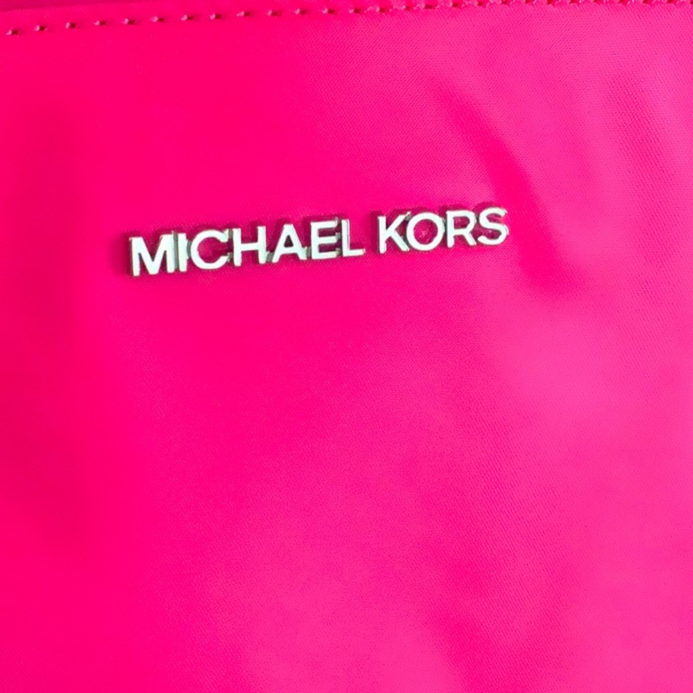 Michael Kors pocket book hot pink with black straps trimmed in gold